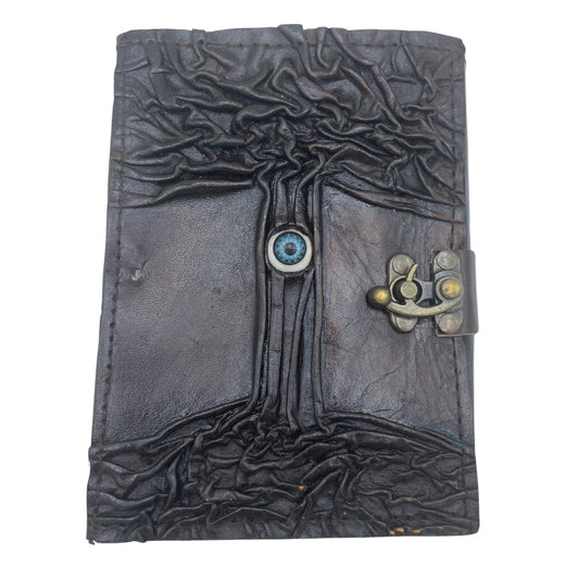 Carnet de notes marron foncé avec bords usés et motif « mauvais œil »